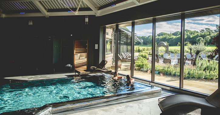 two women talking in the indoor pool inside Ramside Hall spa